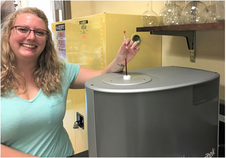 student loads a sample into the Spinsolve NMR at Harrisburg University